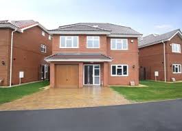 A new-build detached house with a garage and paved drive