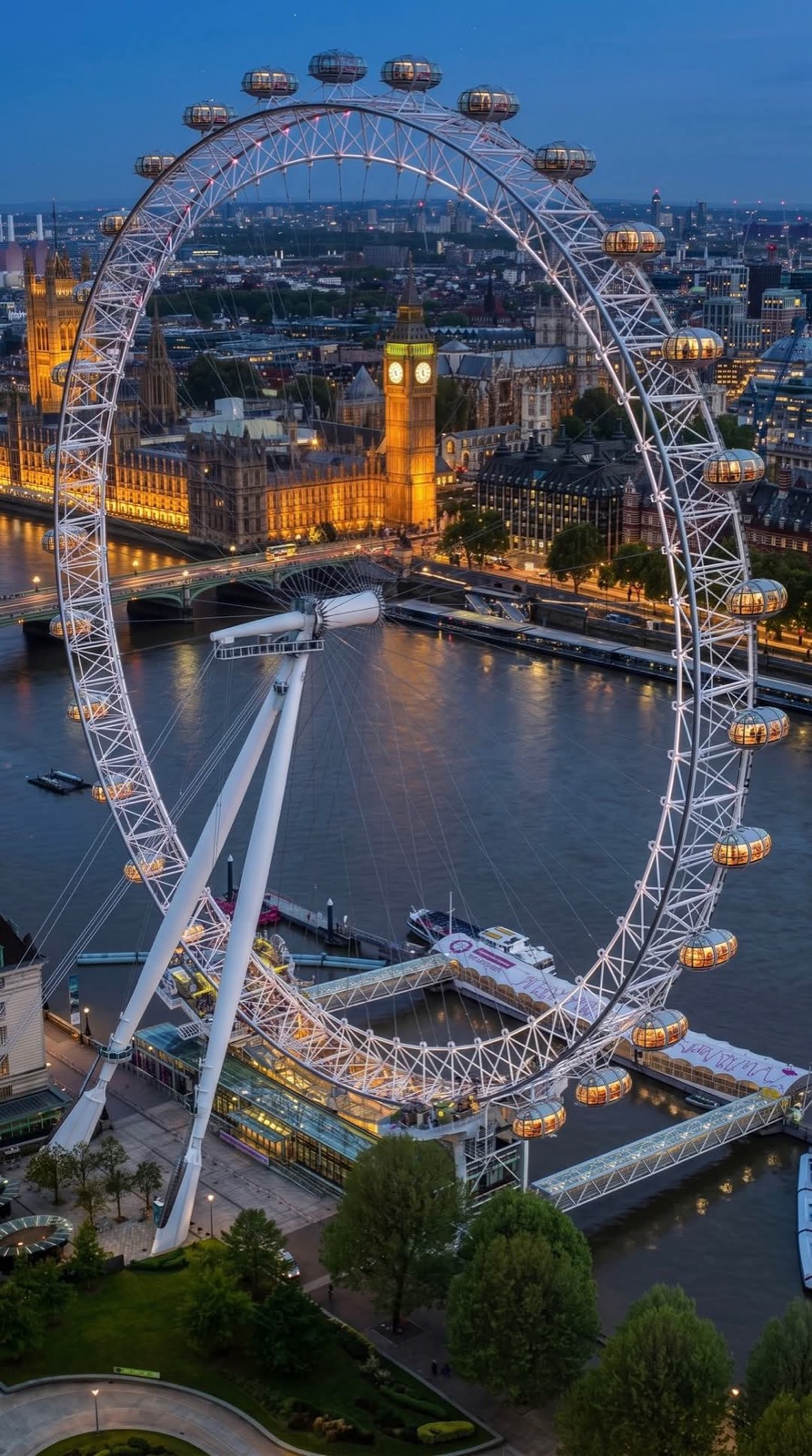 The London Eye with the Houses of Parliament across the Thames at dusk